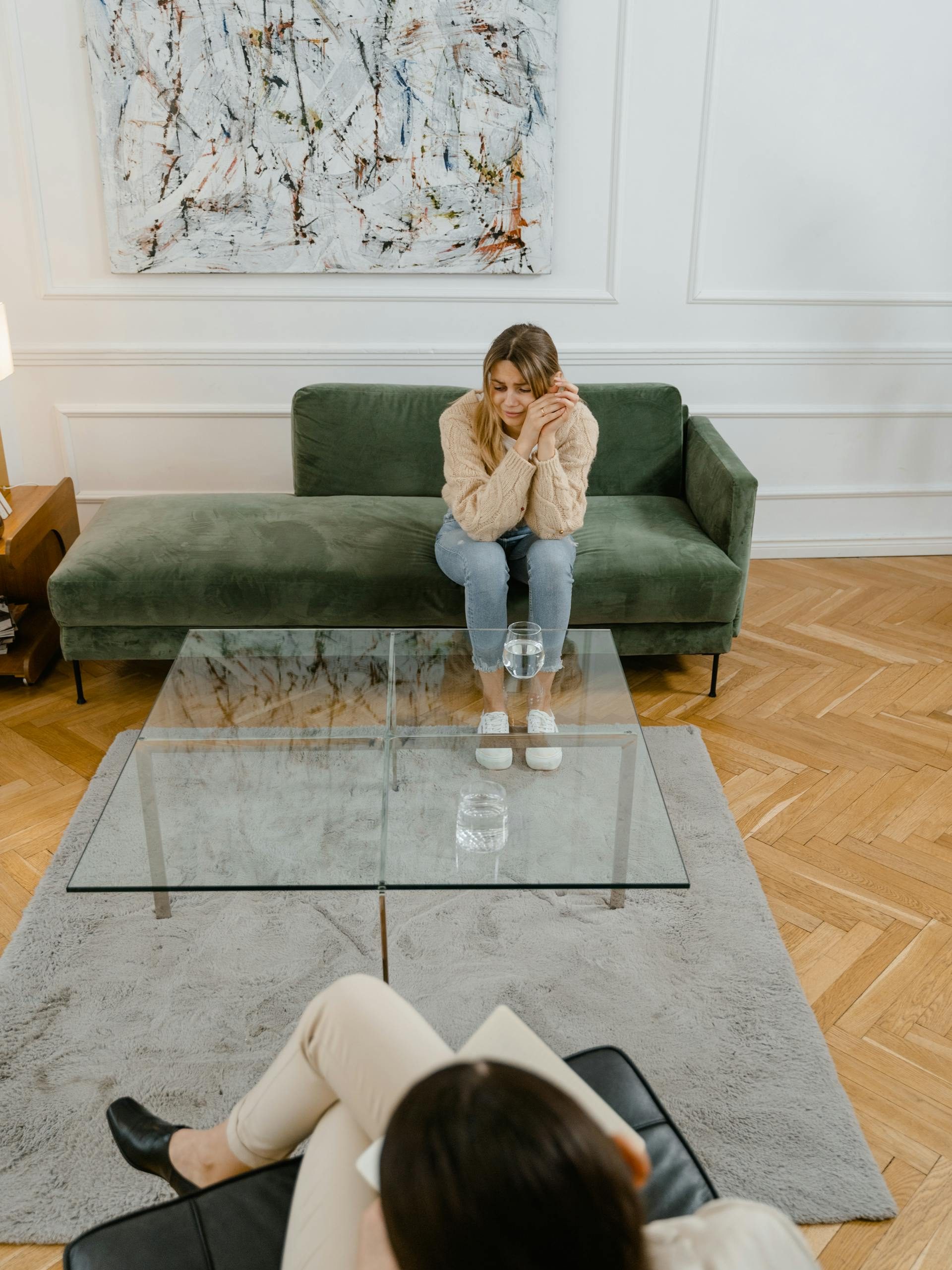An upset girl speaking to someone through counselling.
